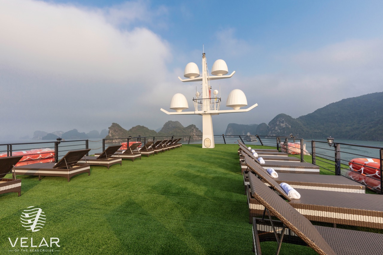 Luxury cruise balcony overlooking Halong Bay with scenic mountain views and relaxing atmosphere.