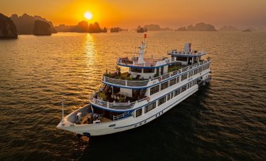 Stunning sunset over Halong Bay with a luxurious cruise ship at dusk, perfect for scenic travel and.