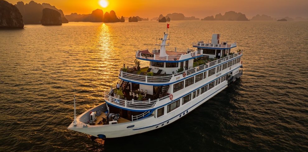 Stunning sunset over Halong Bay with a luxurious cruise ship at dusk, perfect for scenic travel and.