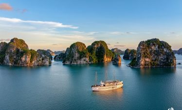Bai Tu Long Bay cruise scene with limestone islands and calm waters, perfect for scenic exploration.