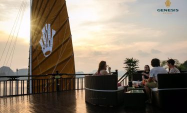 Scenic Halong Bay cruise balcony with friends enjoying sunset views and drinks, capturing the tranqu.