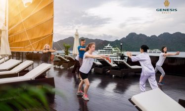 Yoga class on cruise deck with scenic Halong Bay views, people practicing yoga, peaceful and scenic.
