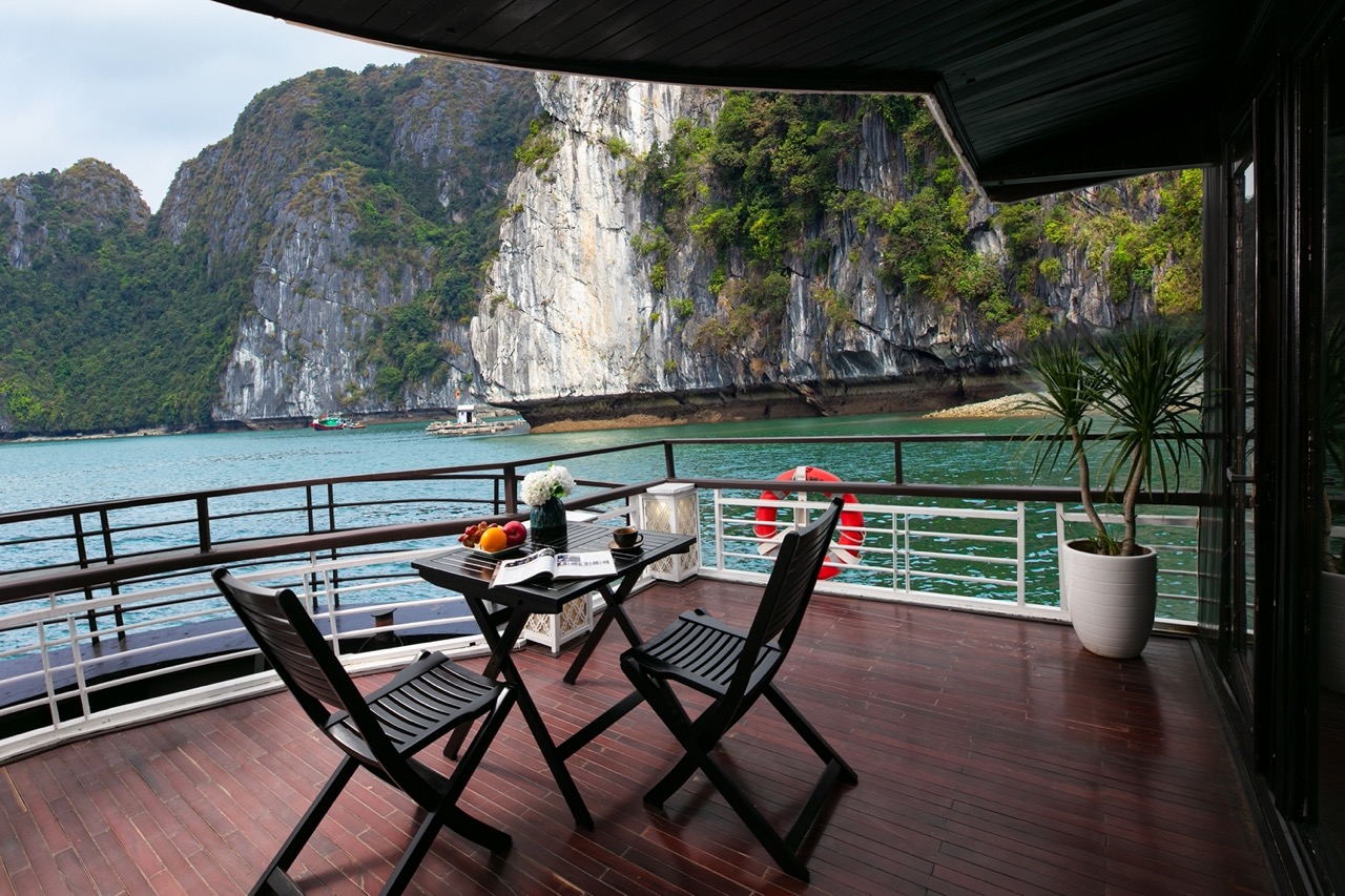 Stunning view of limestone karsts from a luxury cruise balcony in Halong Bay, perfect for relaxing a.