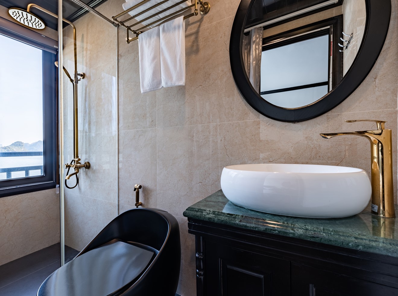 Luxurious Halong Bay cruise bathroom with modern amenities and scenic views.
