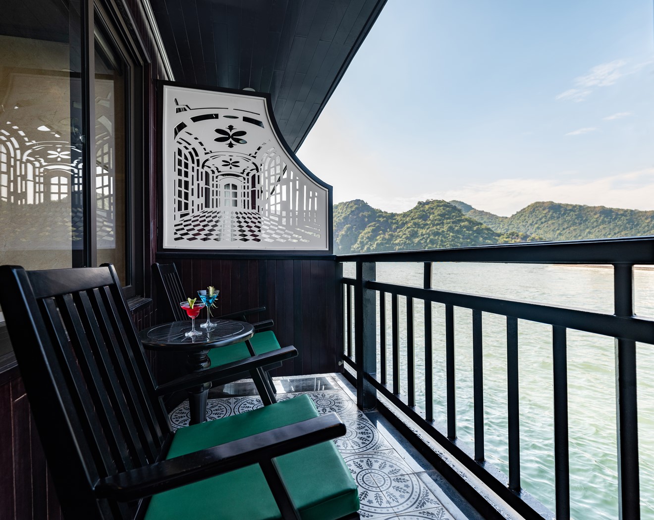 Scenic view of Halong Bay from cruise balcony with lush mountains and calm waters, perfect for a rel.
