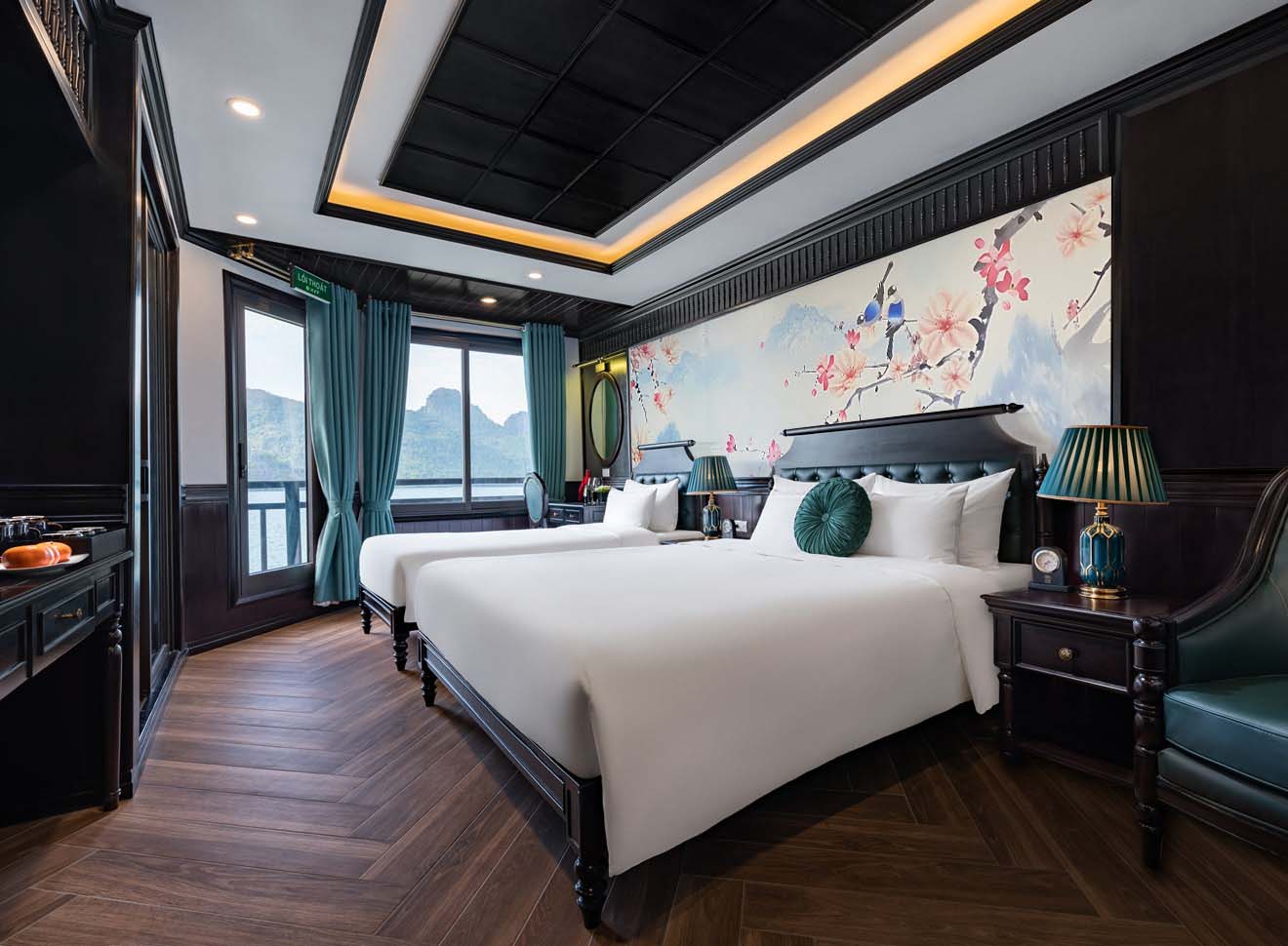 Elegant cruise balcony view of Halong Bay with serene waters and scenic karst formations.