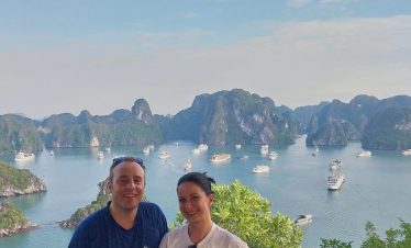 Scenic view of Halong Bay with boats and limestone islands, perfect for a relaxing cruise experience.