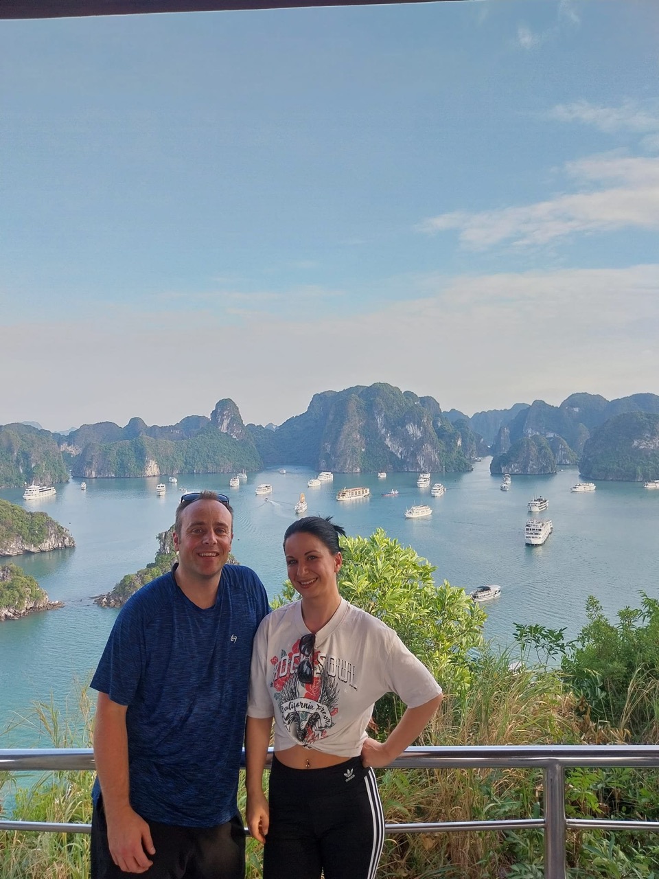 Scenic view of Halong Bay with boats and limestone islands, perfect for a relaxing cruise experience.