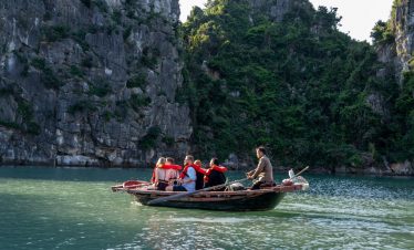 Kayaking tour on Bai Tu Long Bay featuring scenic limestone cliffs and emerald waters.