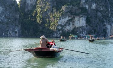 Kayaking scene on Halong Bay with scenic limestone karsts and tranquil waters, perfect for exploring.