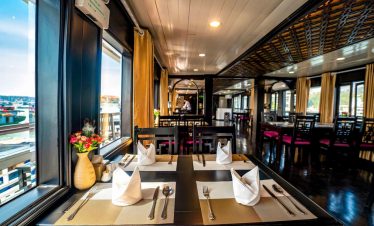 Elegant cruise balcony scene showcasing stunning Halong Bay vistas and serene waters.