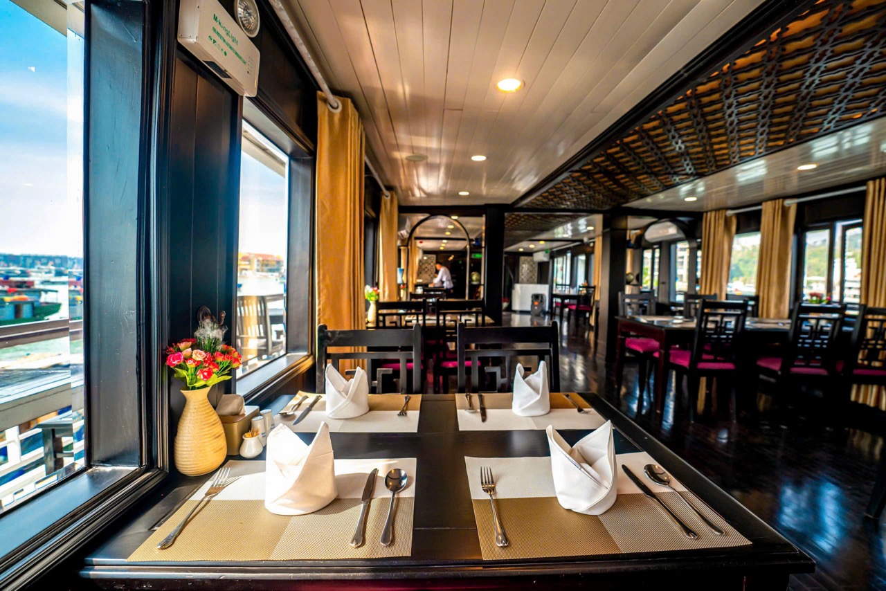 Elegant cruise balcony scene showcasing stunning Halong Bay vistas and serene waters.