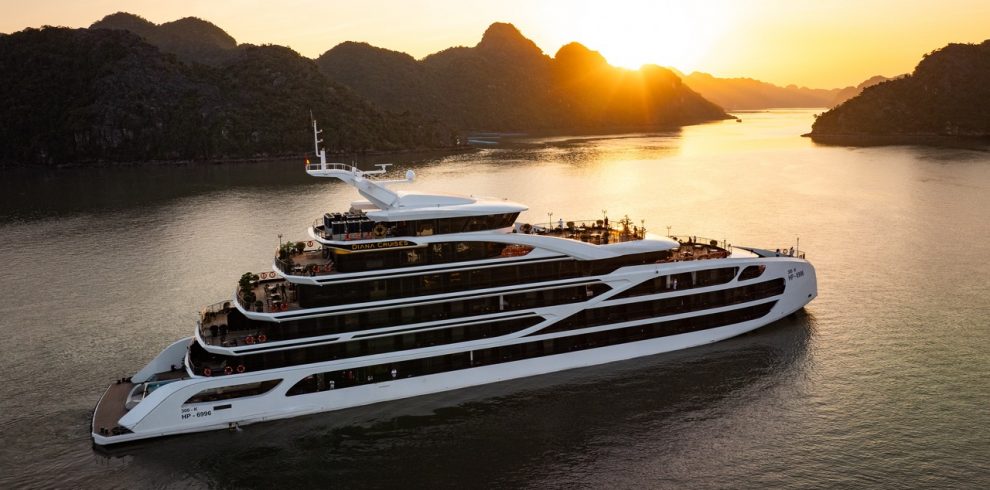 A modern luxury cruise ship sailing through Lan Ha Bay's stunning limestone karsts during sunset, pe.