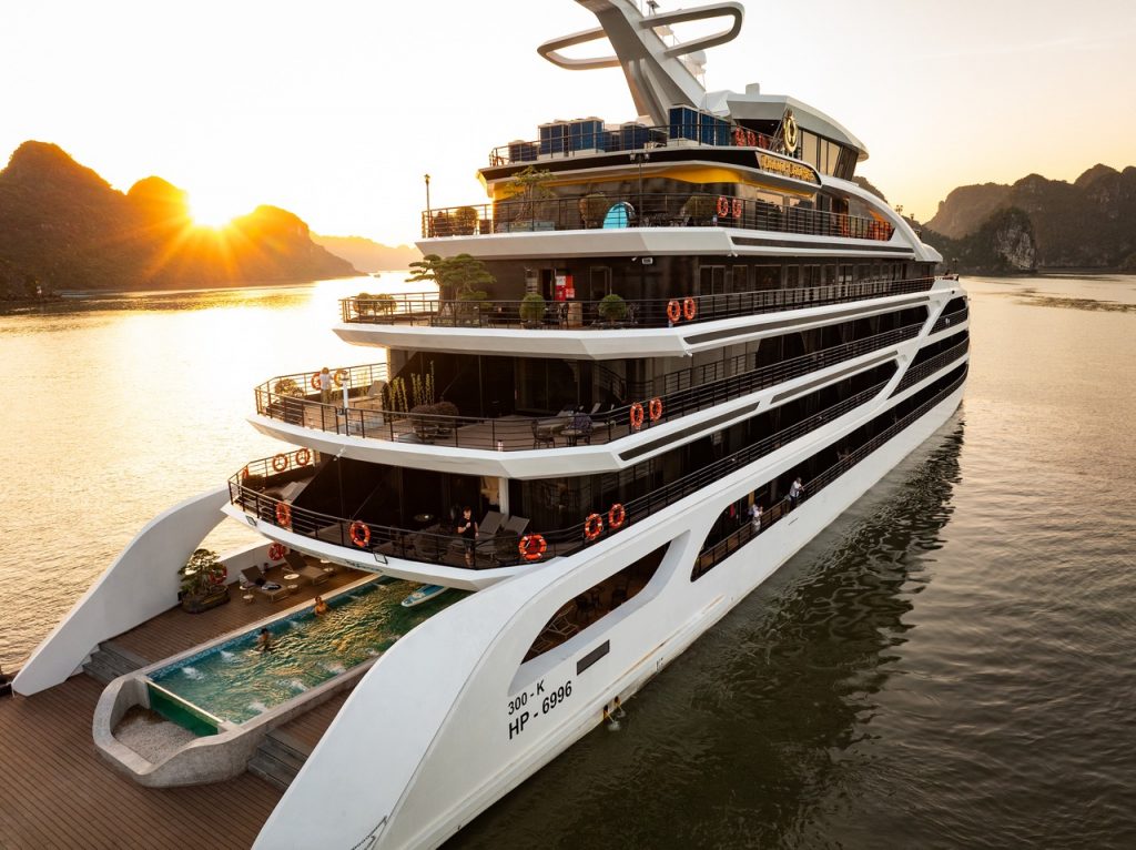 Stunning view of a modern cruise ship sailing in Lan Ha Bay at sunset, perfect for luxury travel and.