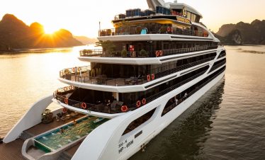 Stunning view of a modern cruise ship sailing in Lan Ha Bay at sunset, perfect for luxury travel and.