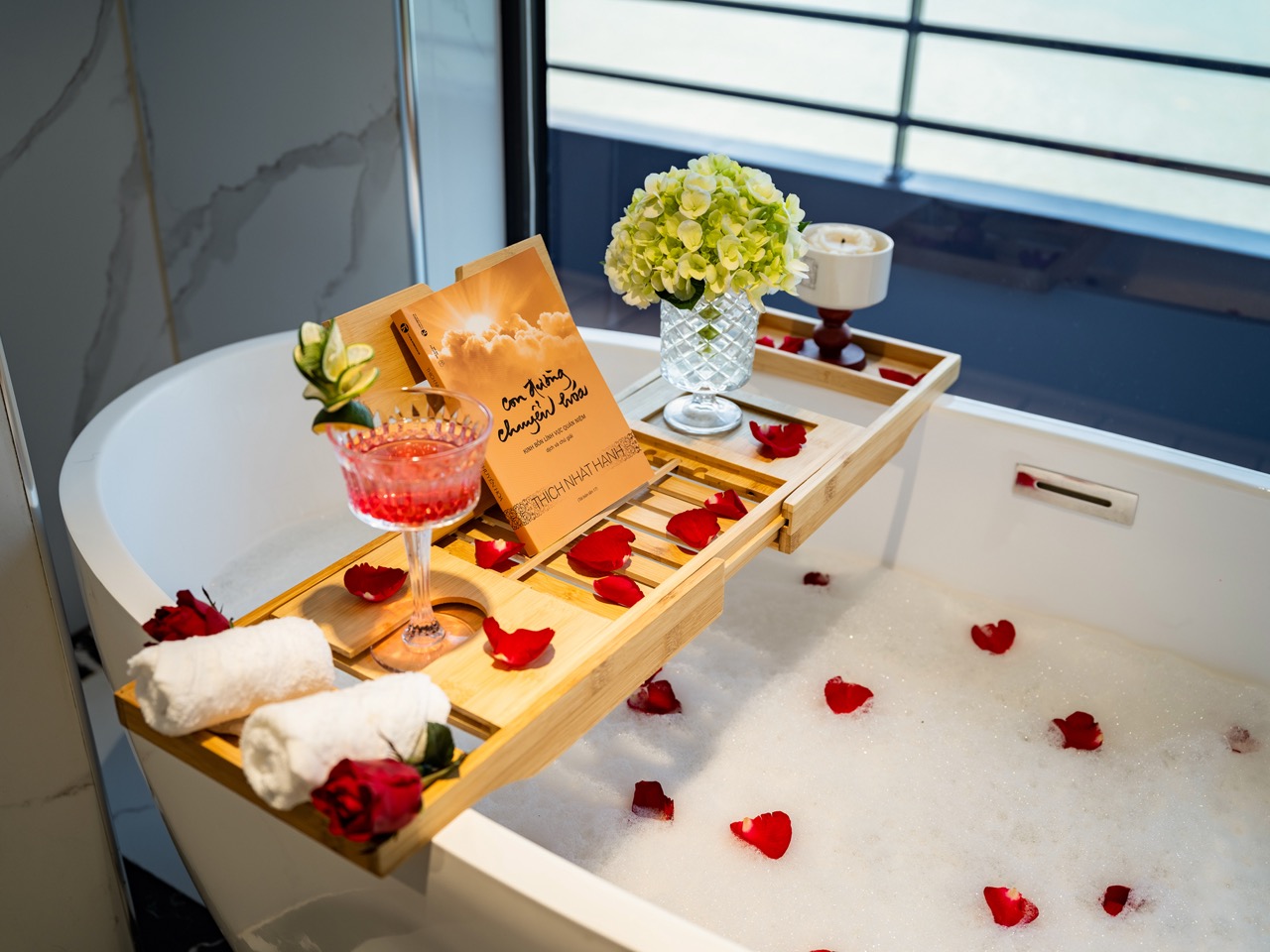 Romantic Lan Ha Bay cruise balcony scene with rose petals, flowers, and scenic water views, perfect.