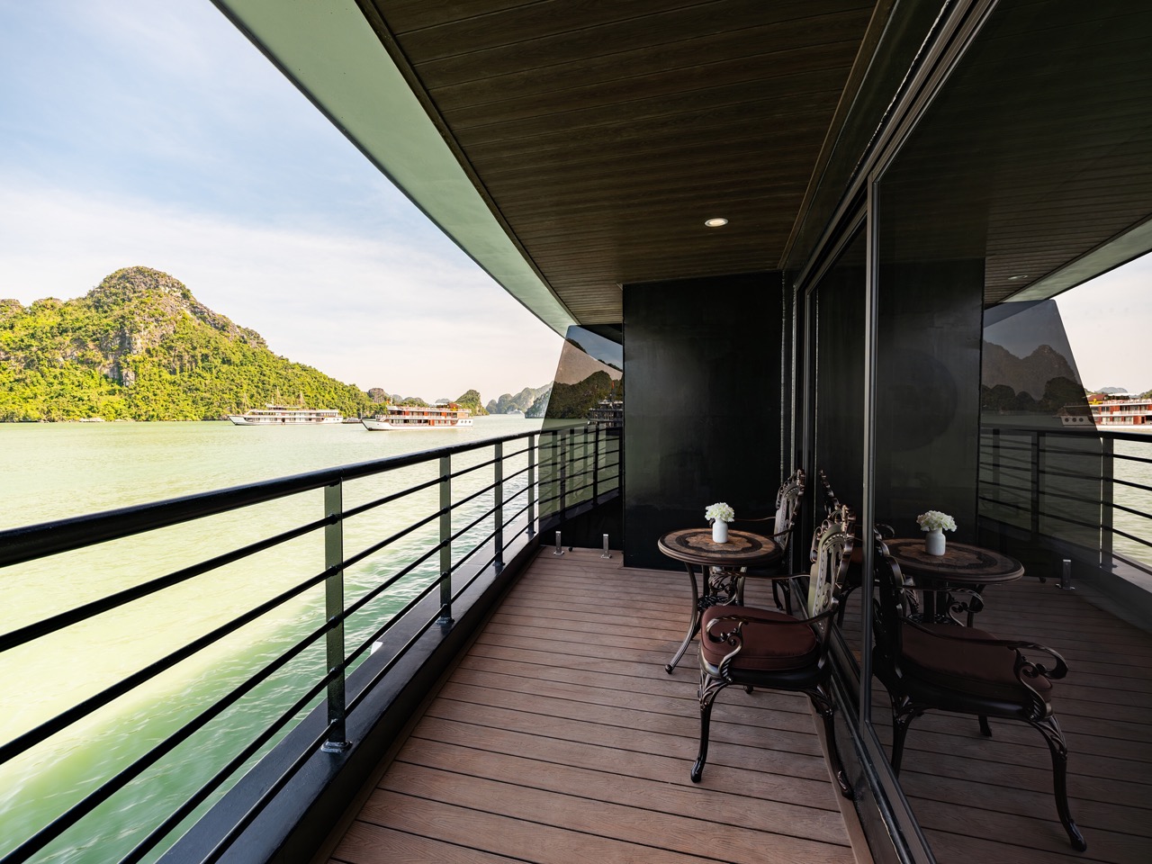 Stunning view from a cruise balcony overlooking Halong Bay's emerald waters and limestone islands, p.
