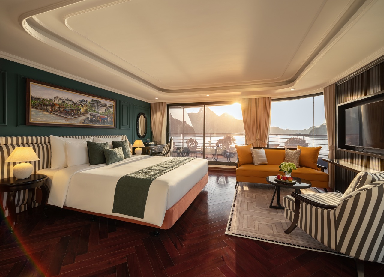 Scenic Lan Ha Bay cruise balcony showcasing stunning sunset, tranquil waters, and elegant interior f.