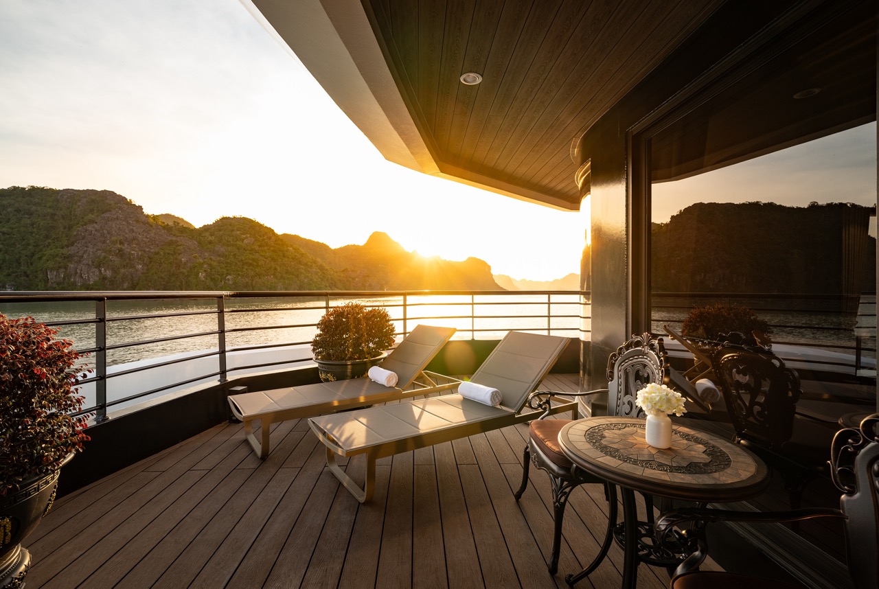 Stunning view from a cruise balcony in Halong Bay at sunset, perfect for relaxing and enjoying the s.