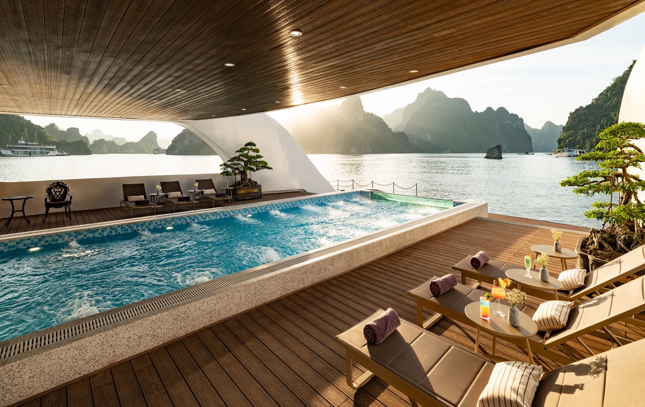 Relaxing scene of a cruise balcony with pool overlooking Lan Ha Bay, perfect for a tranquil travel e.