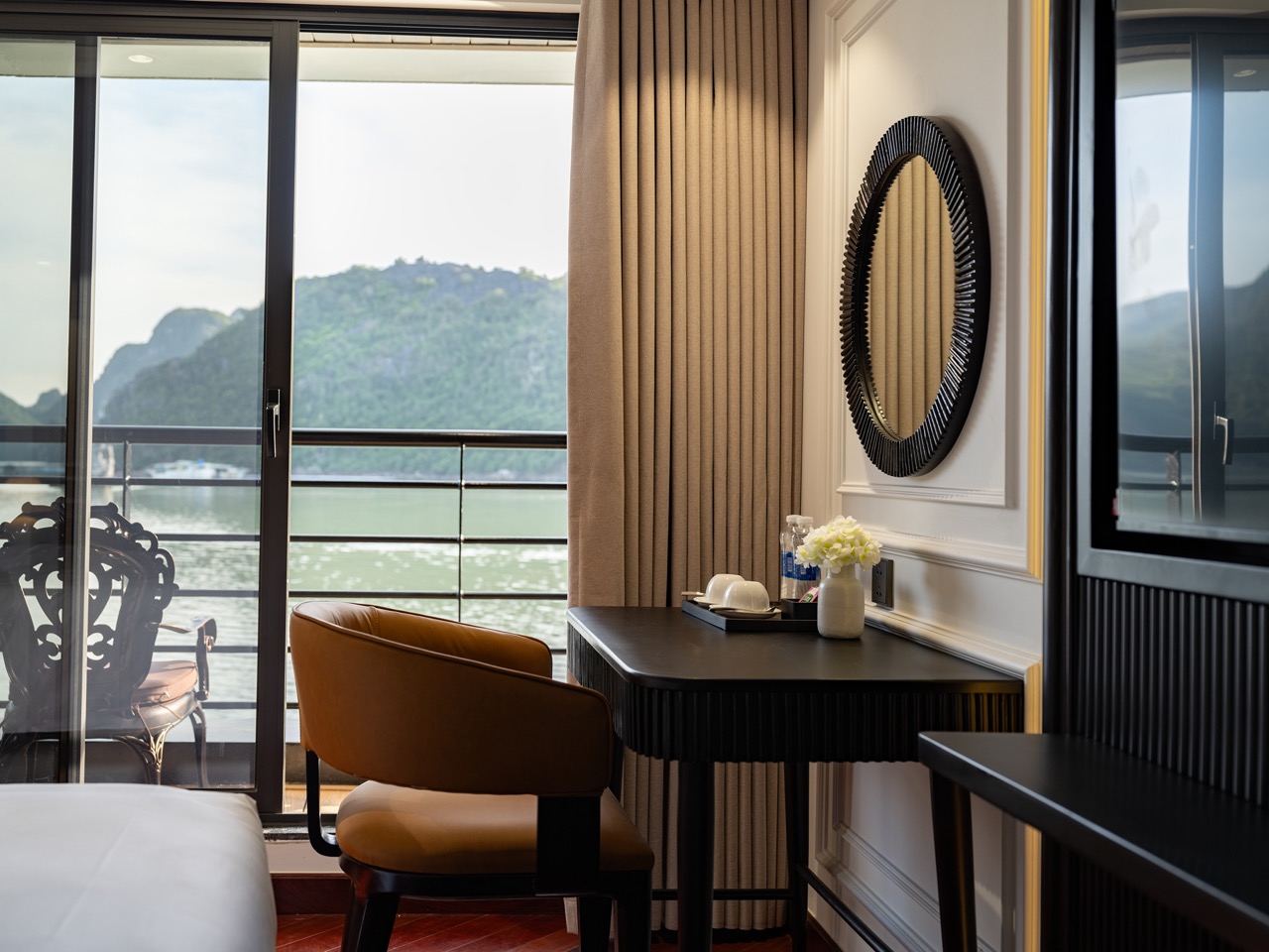 Luxurious cruise balcony overlooking Lan Ha Bay with scenic mountain views, perfect for a relaxing g.