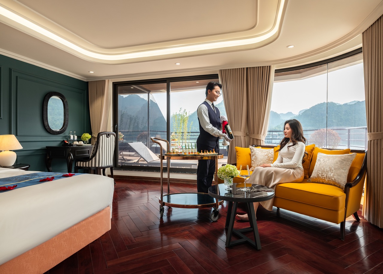 Relaxing scene on a cruise balcony in Lan Ha Bay with stunning mountain views and elegant interior.