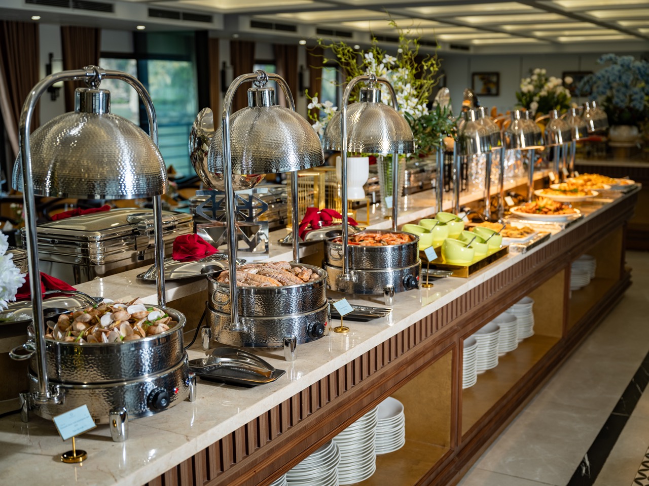 Elegant buffet setup on a luxury cruise in Lan Ha Bay, showcasing diverse dishes and a sophisticated.