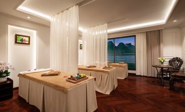 Relaxing spa treatment room with elegant decor and serene ocean views at Lan Ha Bay.