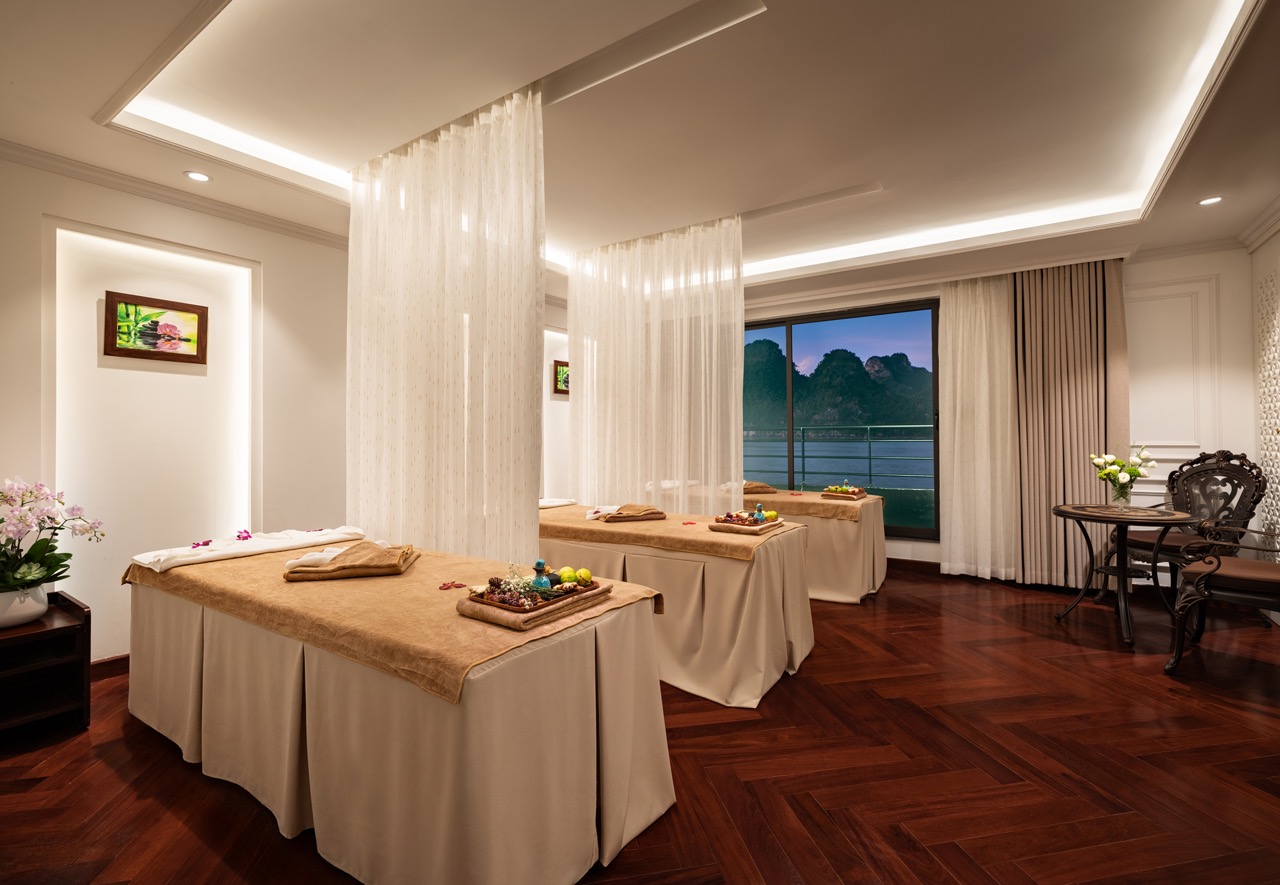 Relaxing spa treatment room with elegant decor and serene ocean views at Lan Ha Bay.