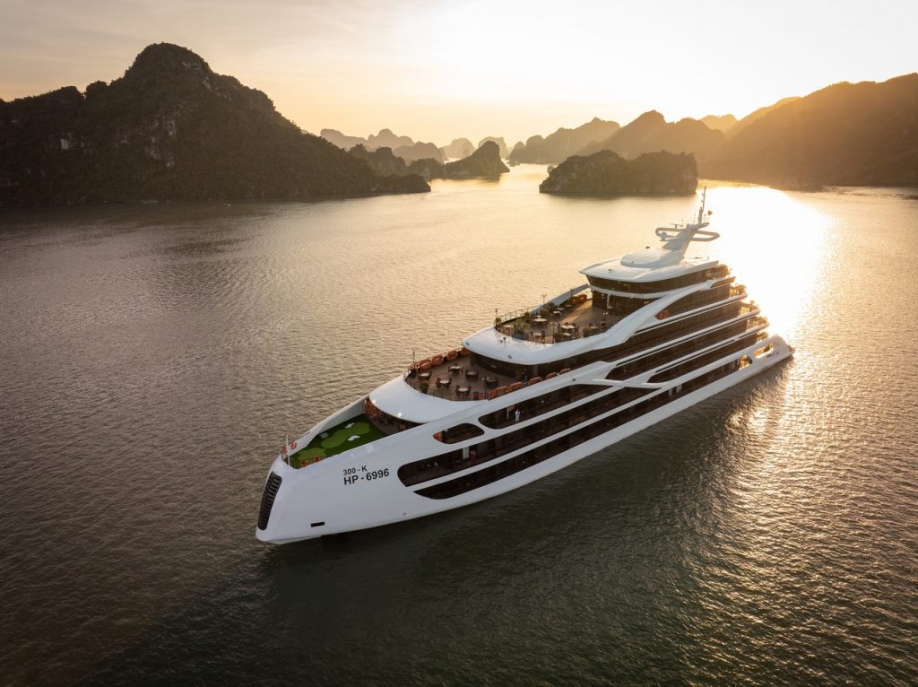 Luxury Lan Ha Bay cruise ship at sunset, showcasing stunning limestone karsts and tranquil waters, p.