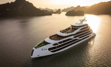 Luxury Lan Ha Bay cruise ship at sunset, showcasing stunning limestone karsts and tranquil waters, p.