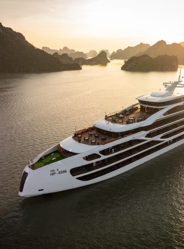 Luxury Lan Ha Bay cruise ship at sunset, showcasing stunning limestone karsts and tranquil waters, p.