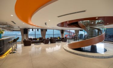 Elegant cruise lounge with panoramic Lan Ha Bay views, modern interior, and relaxing atmosphere.