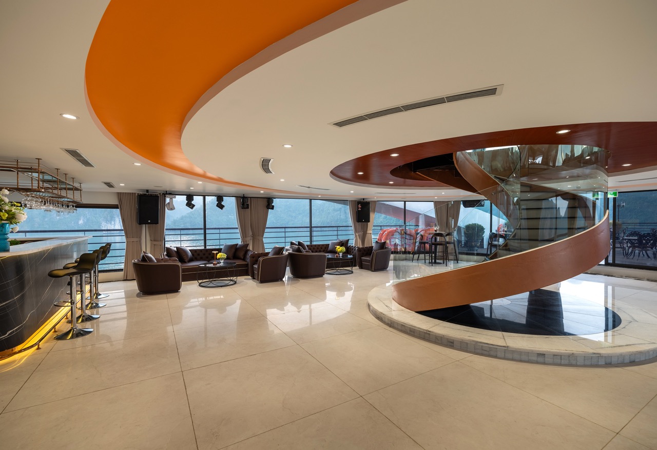 Elegant cruise lounge with panoramic Lan Ha Bay views, modern interior, and relaxing atmosphere.
