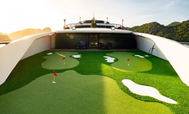 Stunning view of Halong Bay from cruise balcony with mini golf, perfect for relaxing and enjoying sc.
