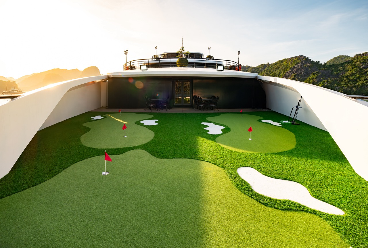 Stunning view of Halong Bay from cruise balcony with mini golf, perfect for relaxing and enjoying sc.