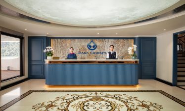 Elegant cruise reception with staff at Halong Bay for luxury travel experience.