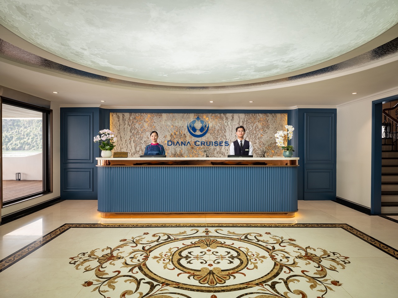 Elegant cruise reception with staff at Halong Bay for luxury travel experience.