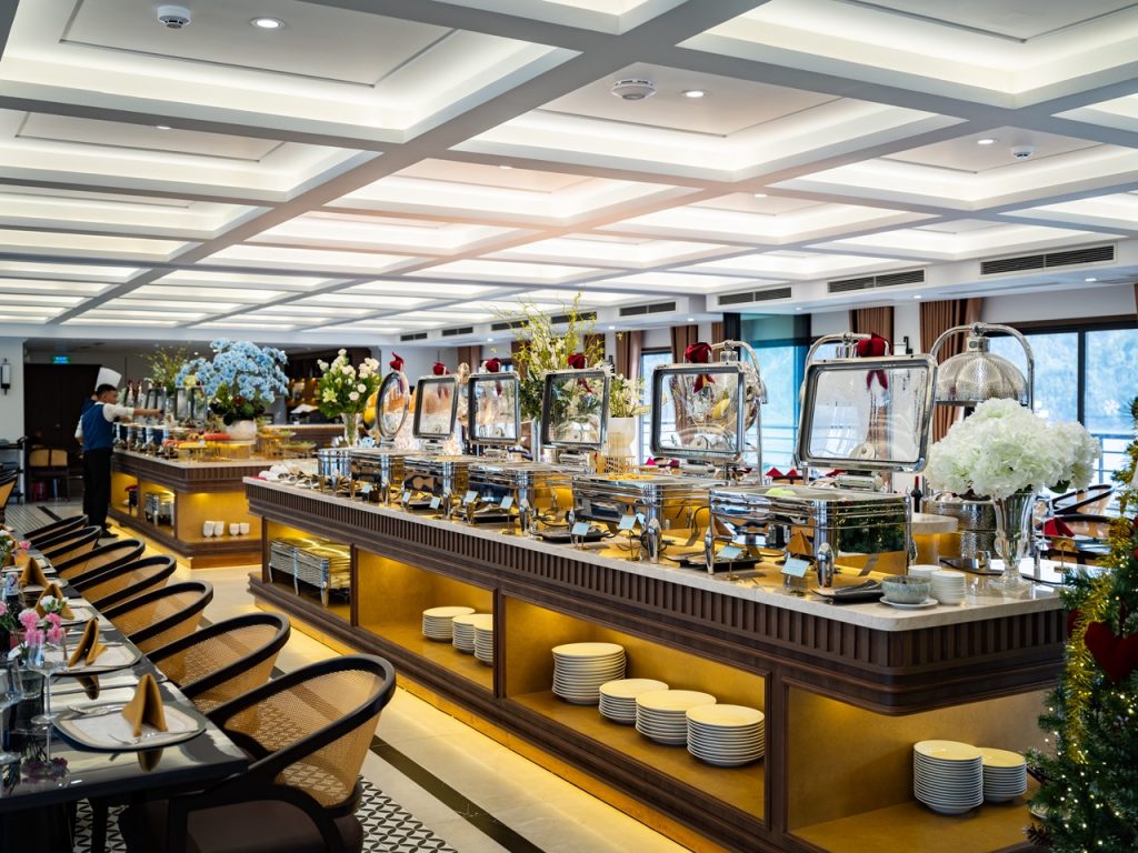 Elegant cruise dining area with buffet setup, modern decor, and scenic bay views, perfect for a rela.