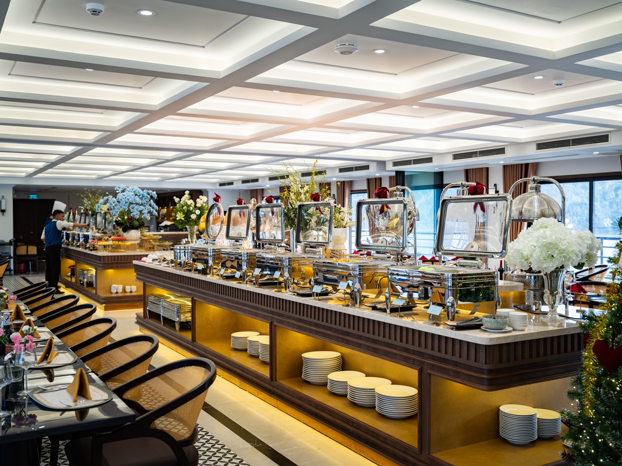 Elegant cruise dining area with buffet setup, modern decor, and scenic bay views, perfect for a rela.
