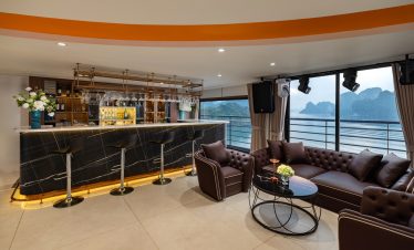 Elegant cruise lounge with panoramic views of Lan Ha Bay, perfect for relaxing and enjoying the scen.