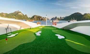 Scenic Lan Ha Bay cruise deck with mountain views, relaxing atmosphere, and vibrant natural scenery.