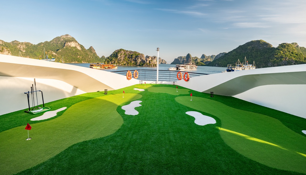 Scenic Lan Ha Bay cruise deck with mountain views, relaxing atmosphere, and vibrant natural scenery.