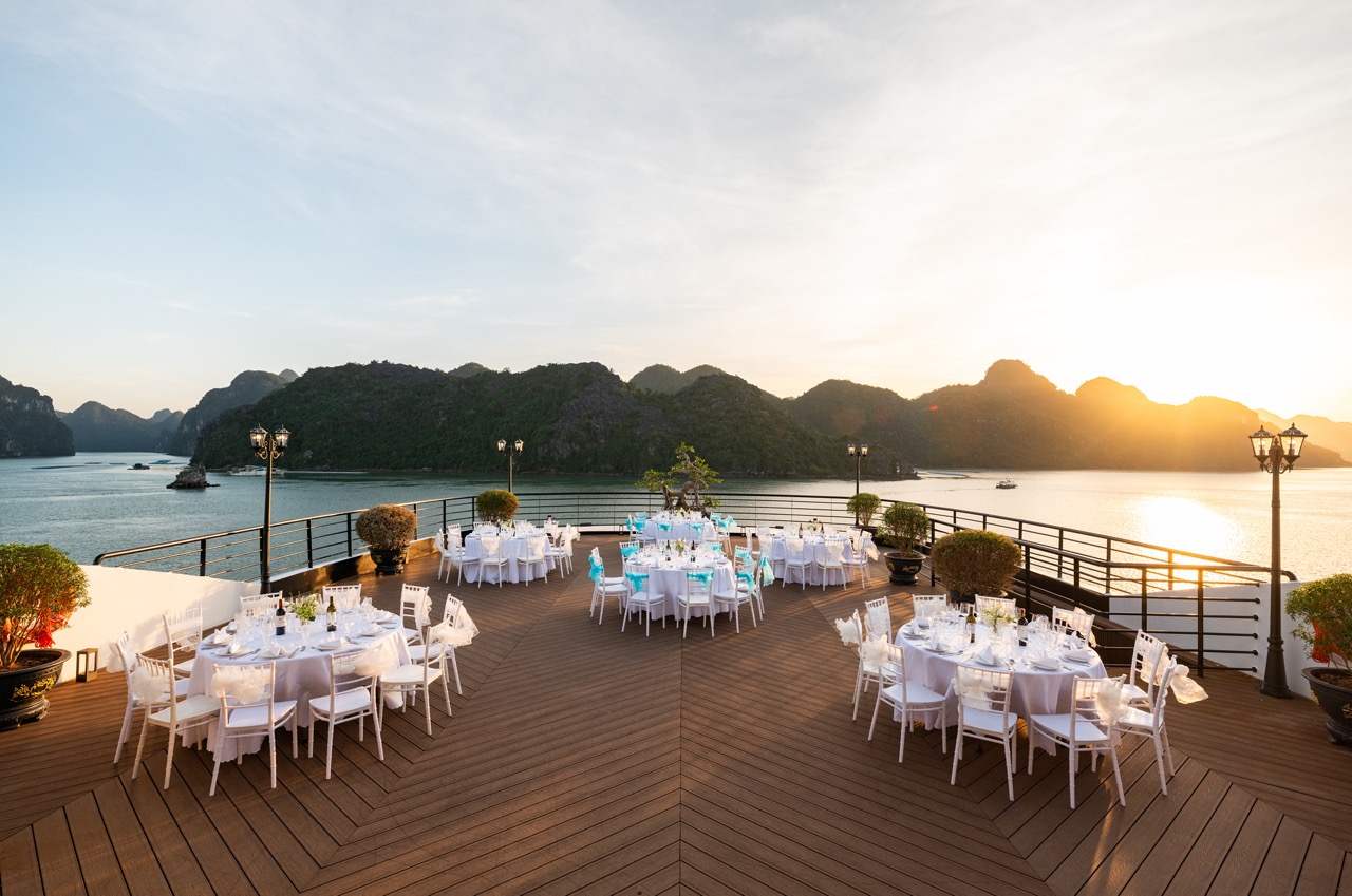 Stunning Lan Ha Bay cruise balcony with sunset, perfect for relaxing and enjoying scenic views.