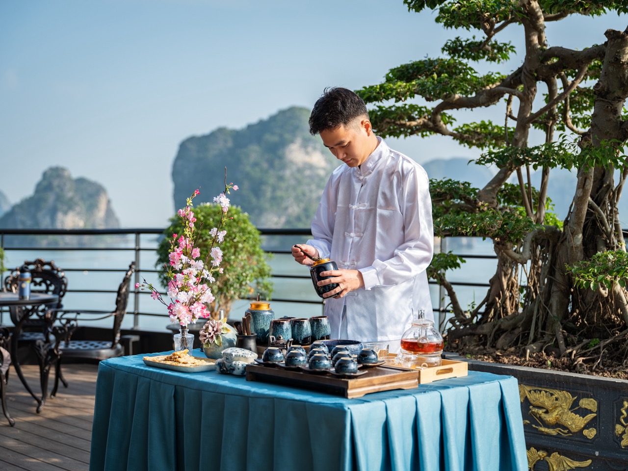 Beautiful scene of a man enjoying a luxurious cruise on Lan Ha Bay with scenic limestone karsts in t.