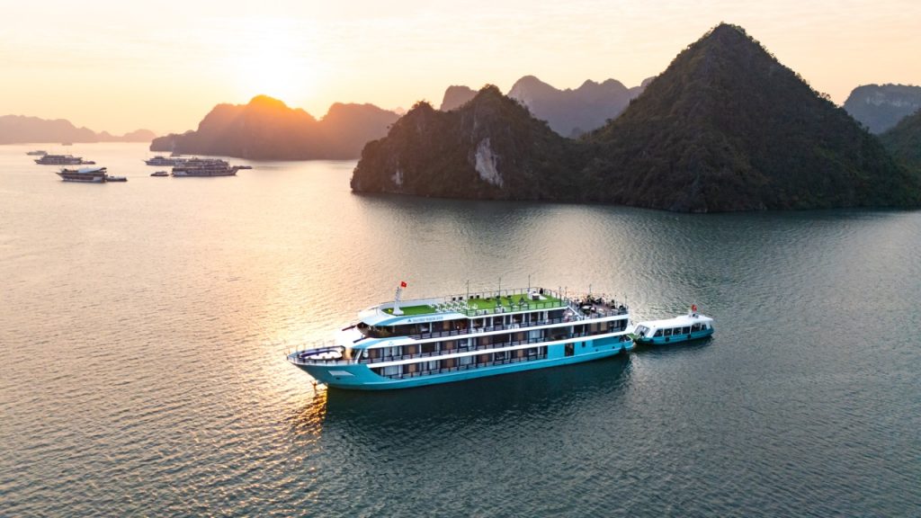 Cruise balcony view of Lan Ha Bay's stunning limestone karsts at sunset.