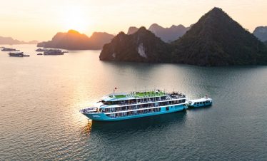 Cruise balcony view of Lan Ha Bay's stunning limestone karsts at sunset.