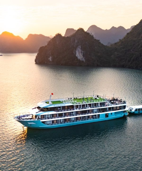 Cruise balcony view of Lan Ha Bay's stunning limestone karsts at sunset.