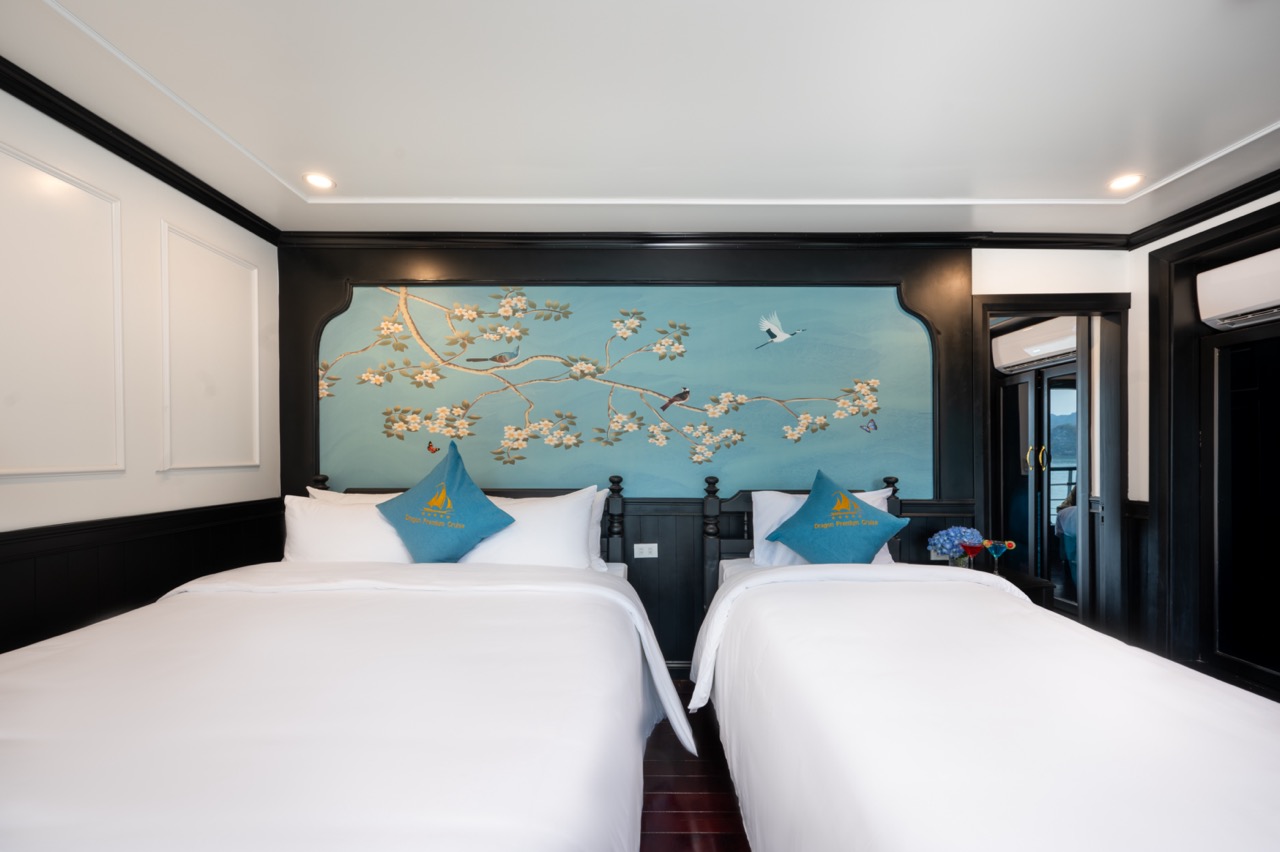 Luxury cruise cabin with elegant decor and scenic views of Lan Ha Bay, perfect for a relaxing getawa.