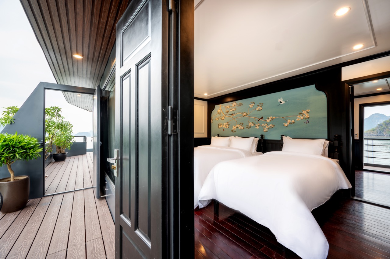 Stunning view from cruise balcony in Halong Bay with calm waters and lush islands.